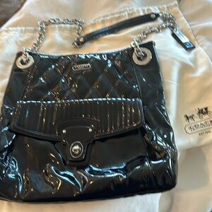 Coach black patent leather quilted bag with dust cover.